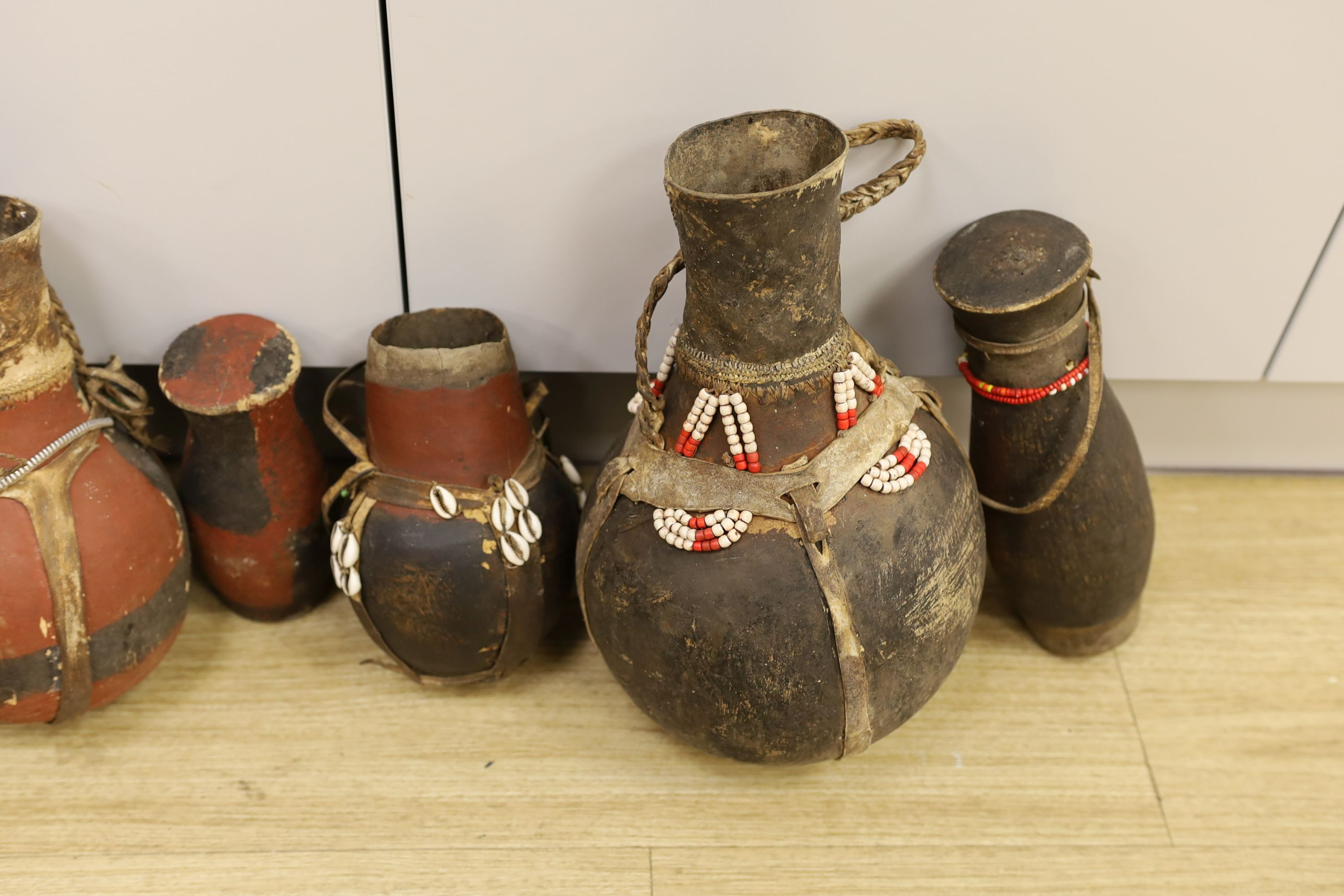 A large quantity of African wood carvings, gourd water carriers, etc.